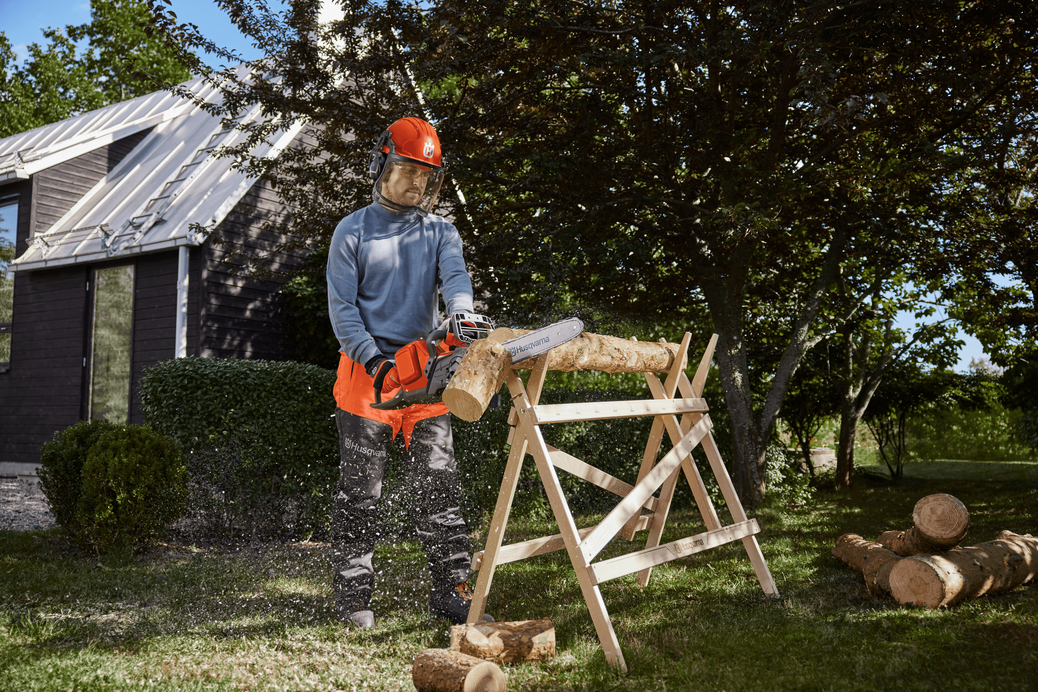 man wearing ppe with chainsaw